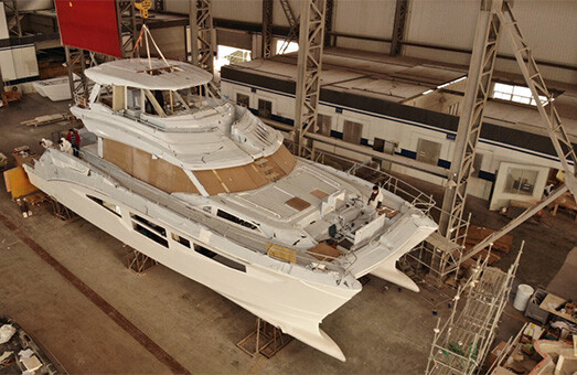 An Aquila power catamaran being constructed in a factory