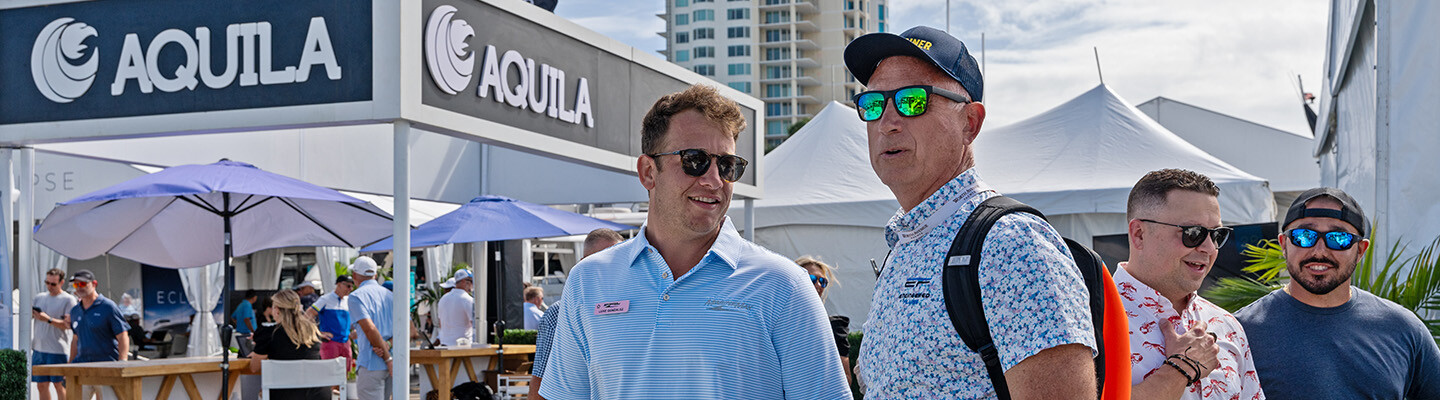 Customer and team member at the booth at the Fort Lauderdale International Boat Show